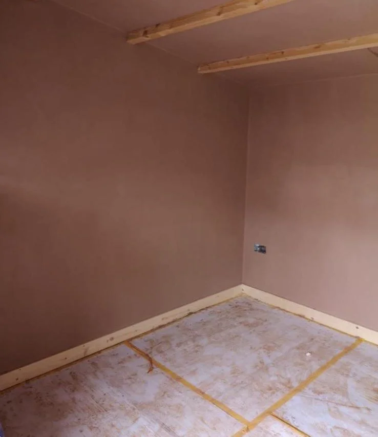 Freshly skimmed interior walls with exposed wooden flooring in Leatherhead Surrey.