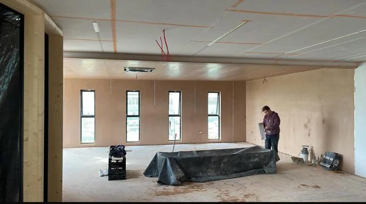 Interior renovation project with plasterboard ceiling and unfinished walls in Guildford Surrey.