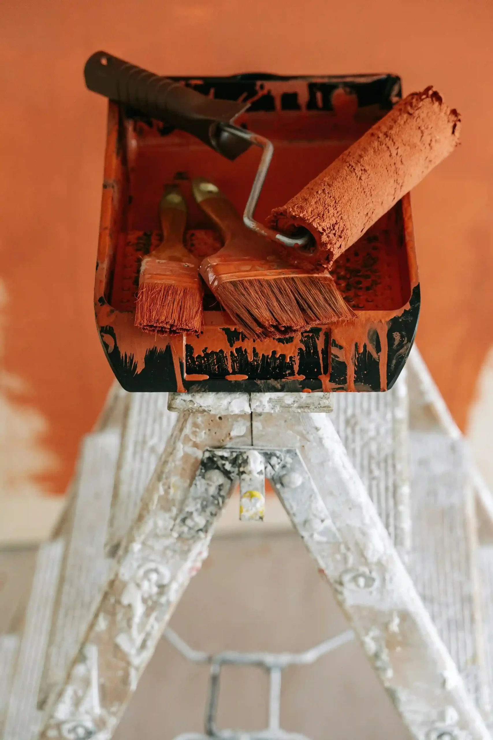 Paint tray with roller and brushes during home renovation project in Surrey.