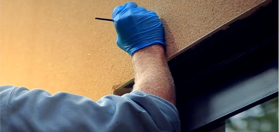 Close-up of textured wall touch-up and plaster repair work in Surrey.