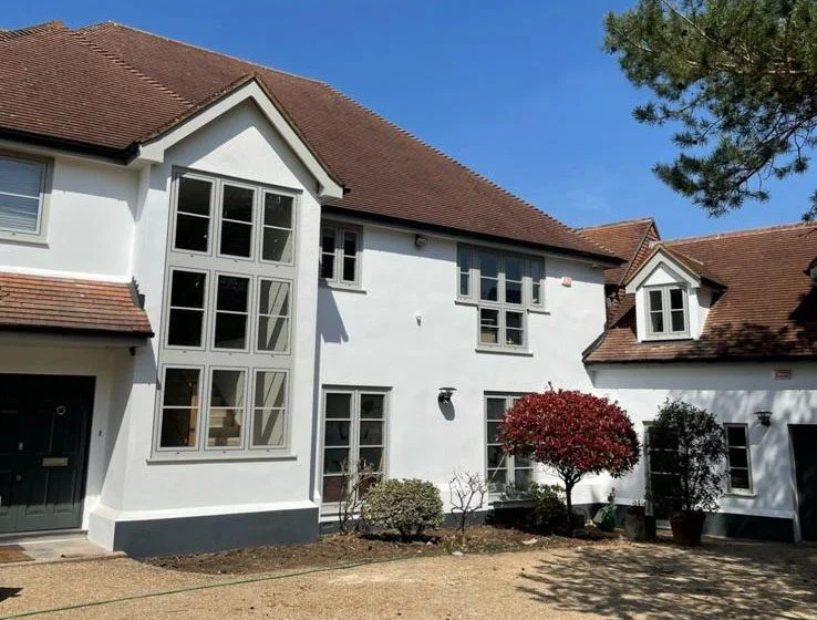 Modern white rendered house with tiled roof in Esher Surrey.